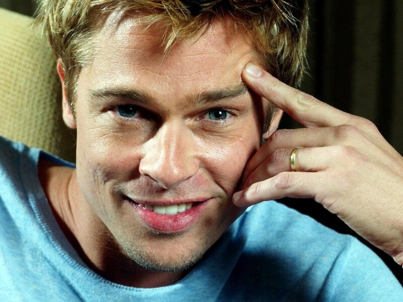 Brad Pitt smiling in blue shirt