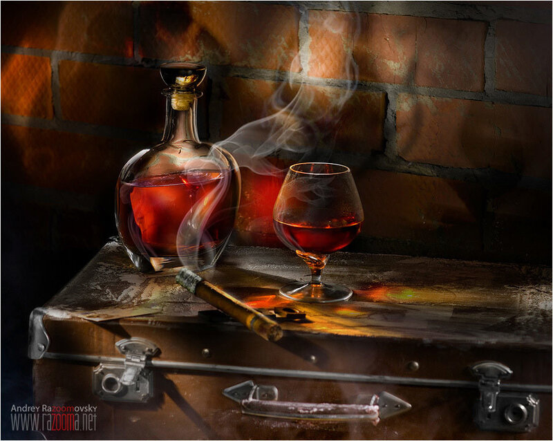 Brandy and cigar on vintage suitcase