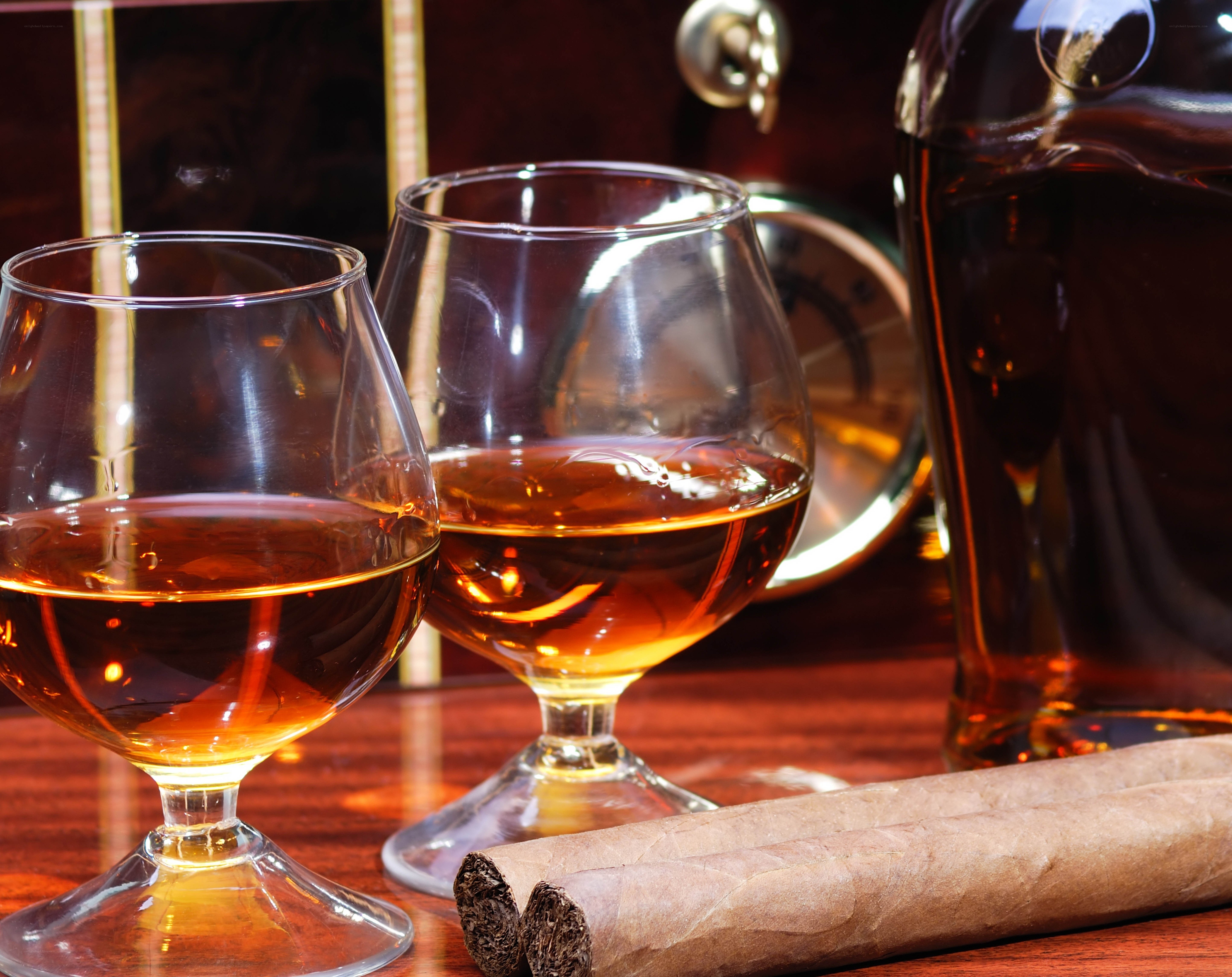 Brandy and cigars on wood