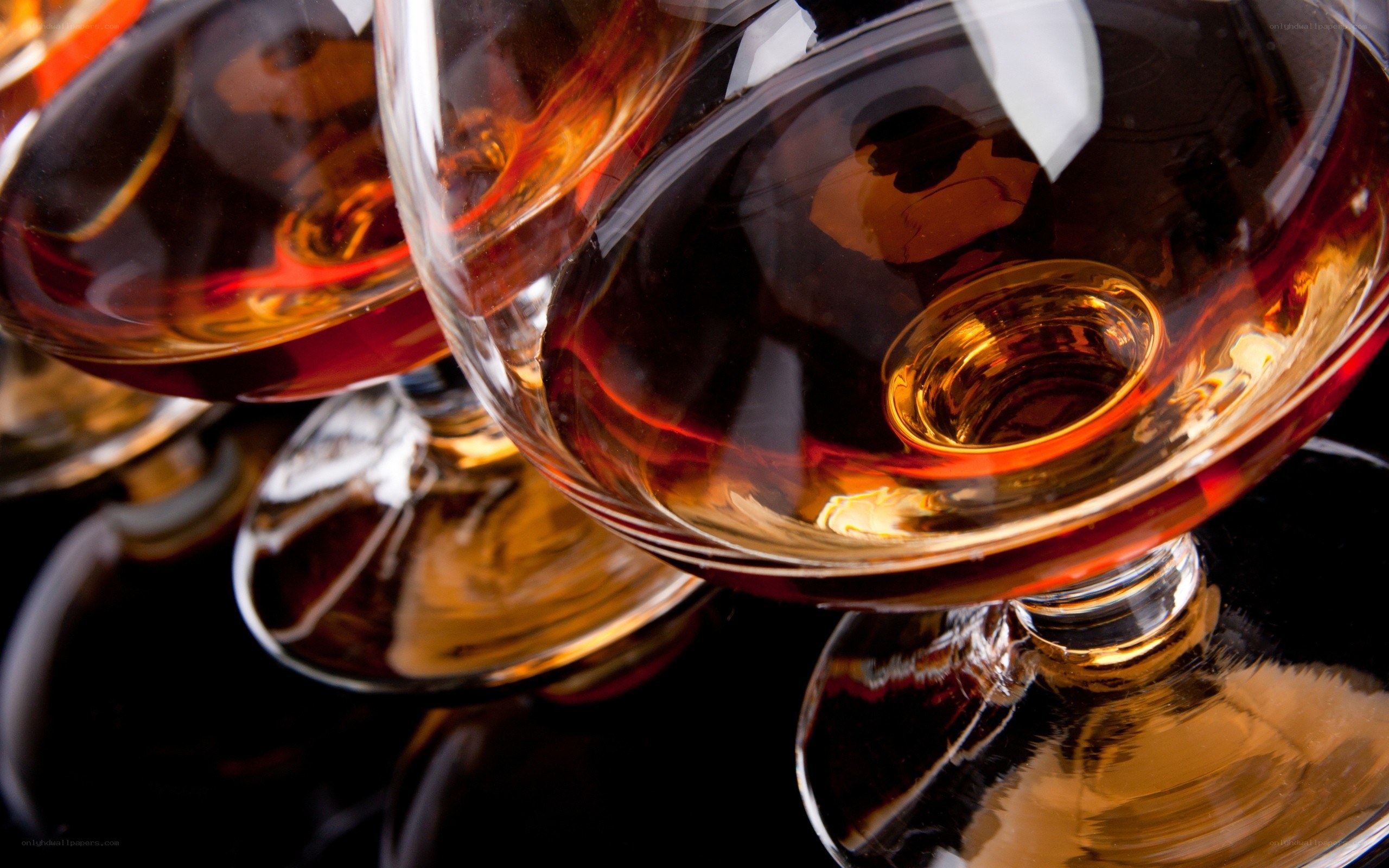 Brandy glasses on dark surface