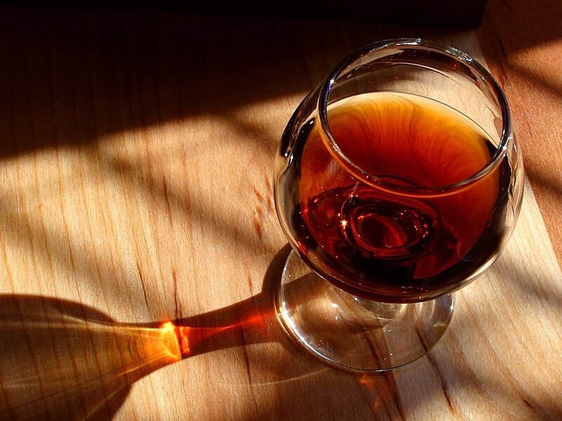 Brandy in a glass on wood