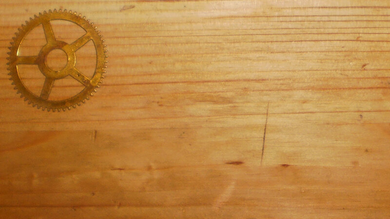 Brass Gear on Wood