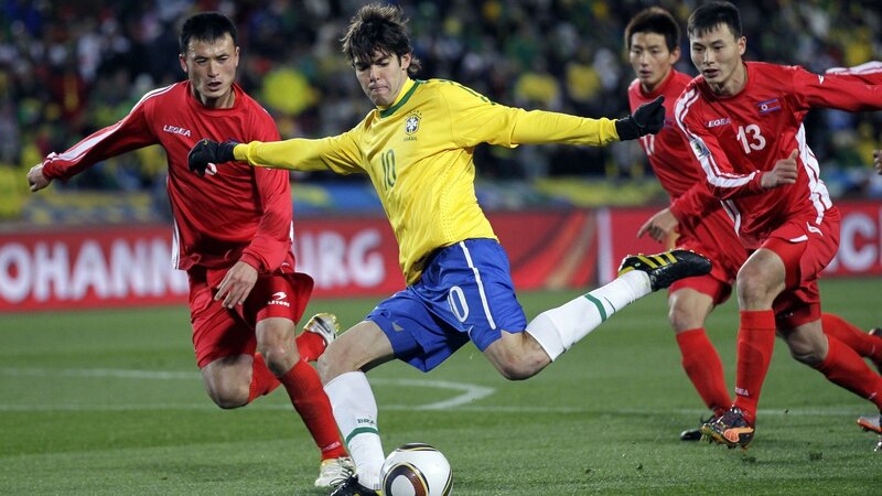 Brazilian player in action against North Korean defenders