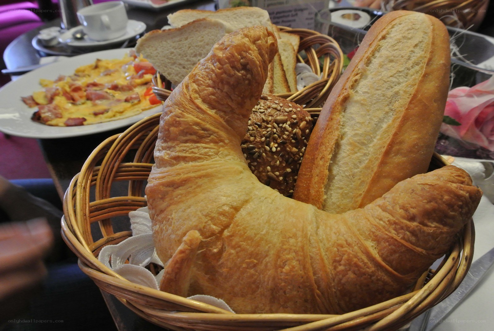 Bread basket with croissant and omelet