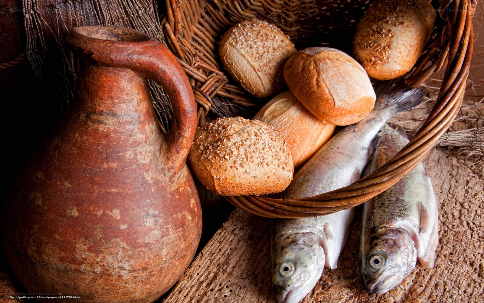 Bread, fish, and jug on wood