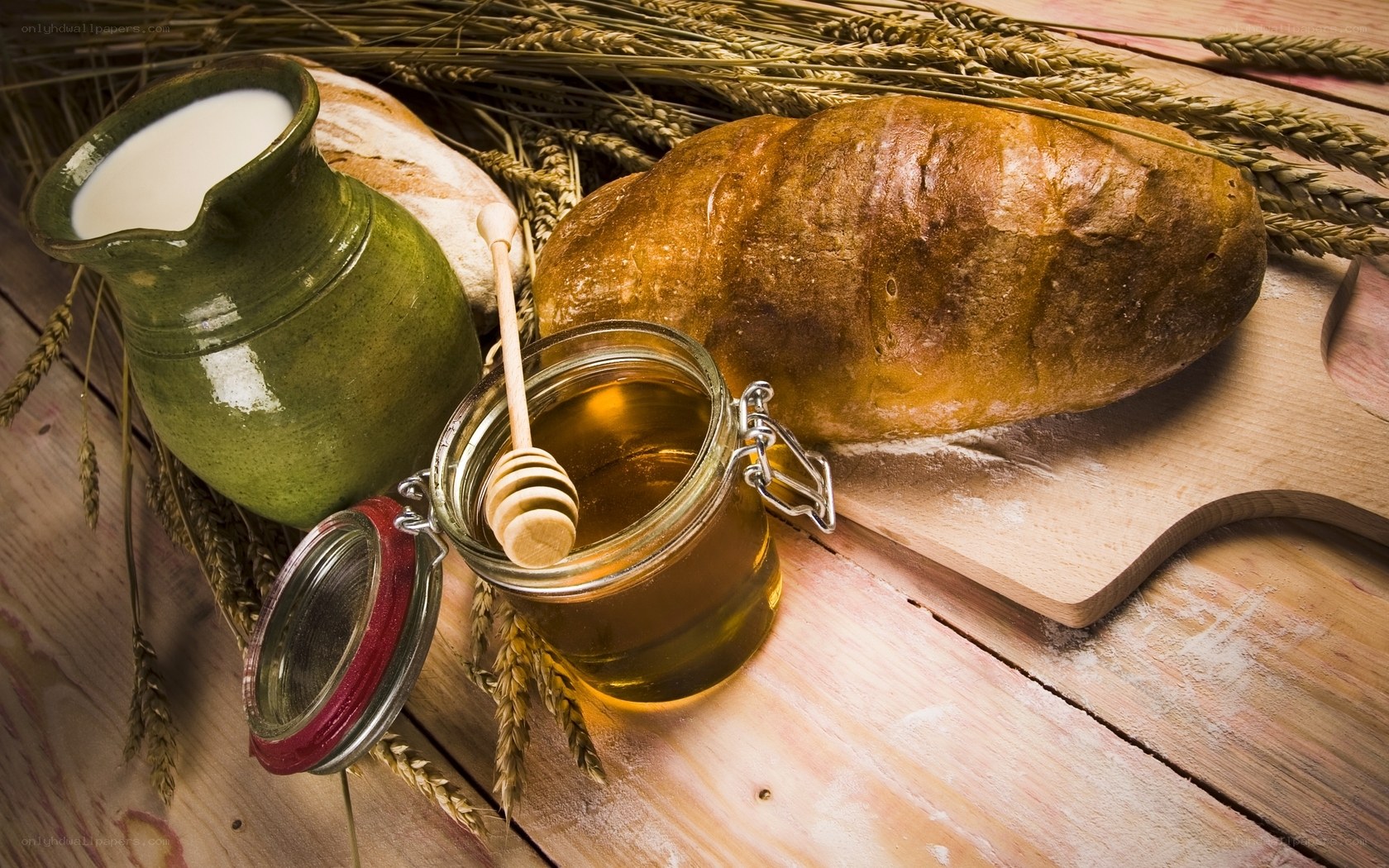 Bread, honey, and milk on wood