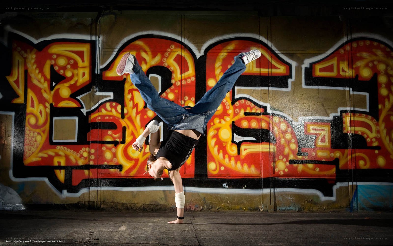 Breakdancer in front of graffiti