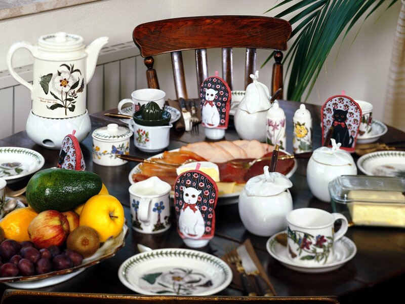 Breakfast table with cat-themed items