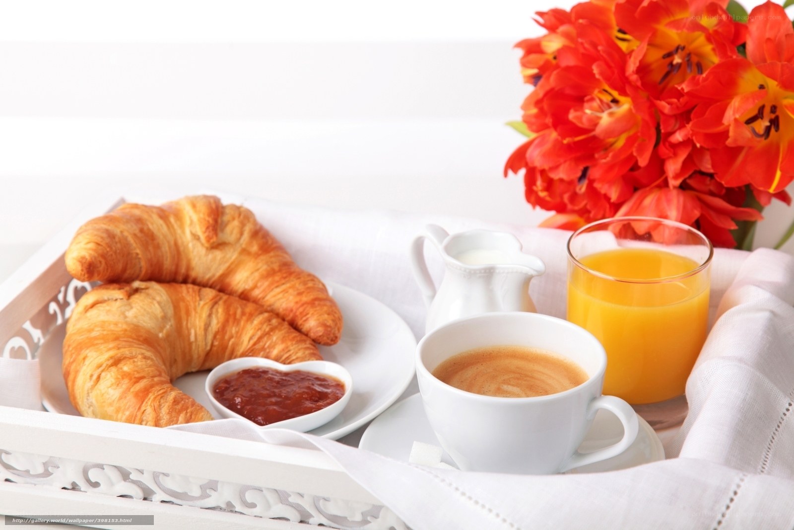 Breakfast tray with croissants and flowers