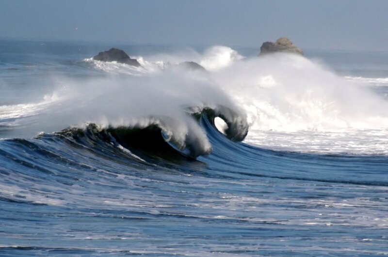 Breaking wave near rocky shore