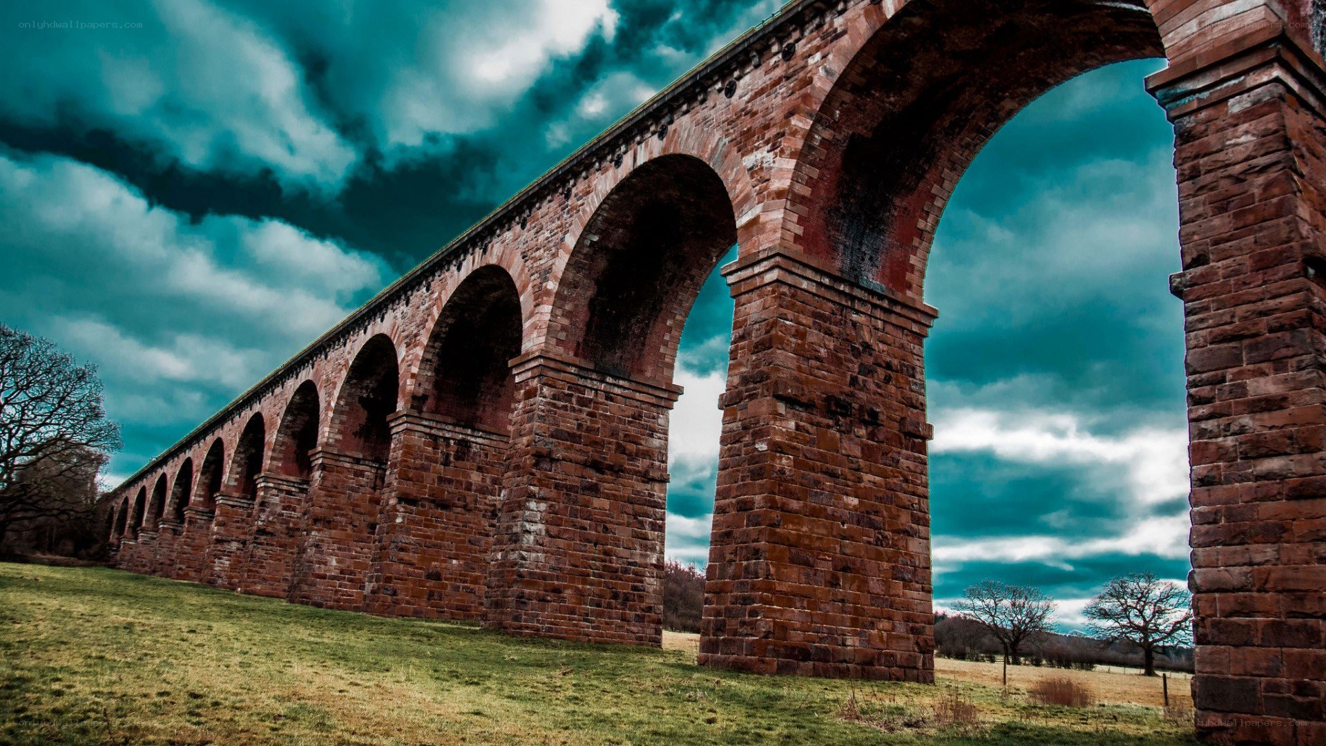 Brick arch viaduct under stormy sky