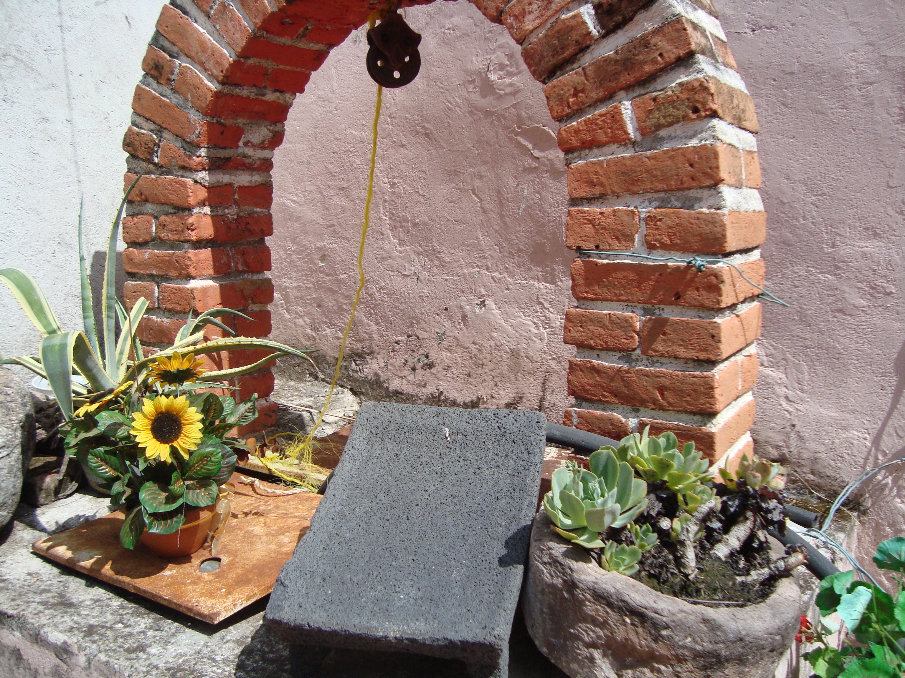 Brick arch with plants and pulley