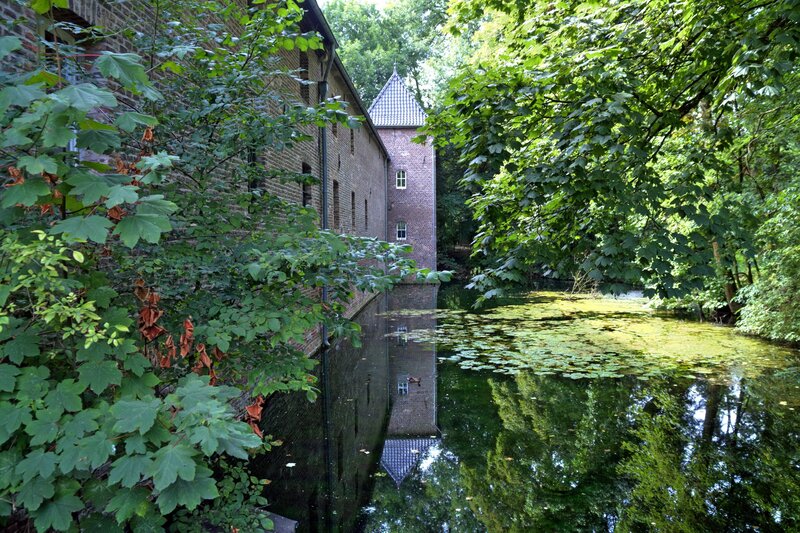 Brick building by a pond