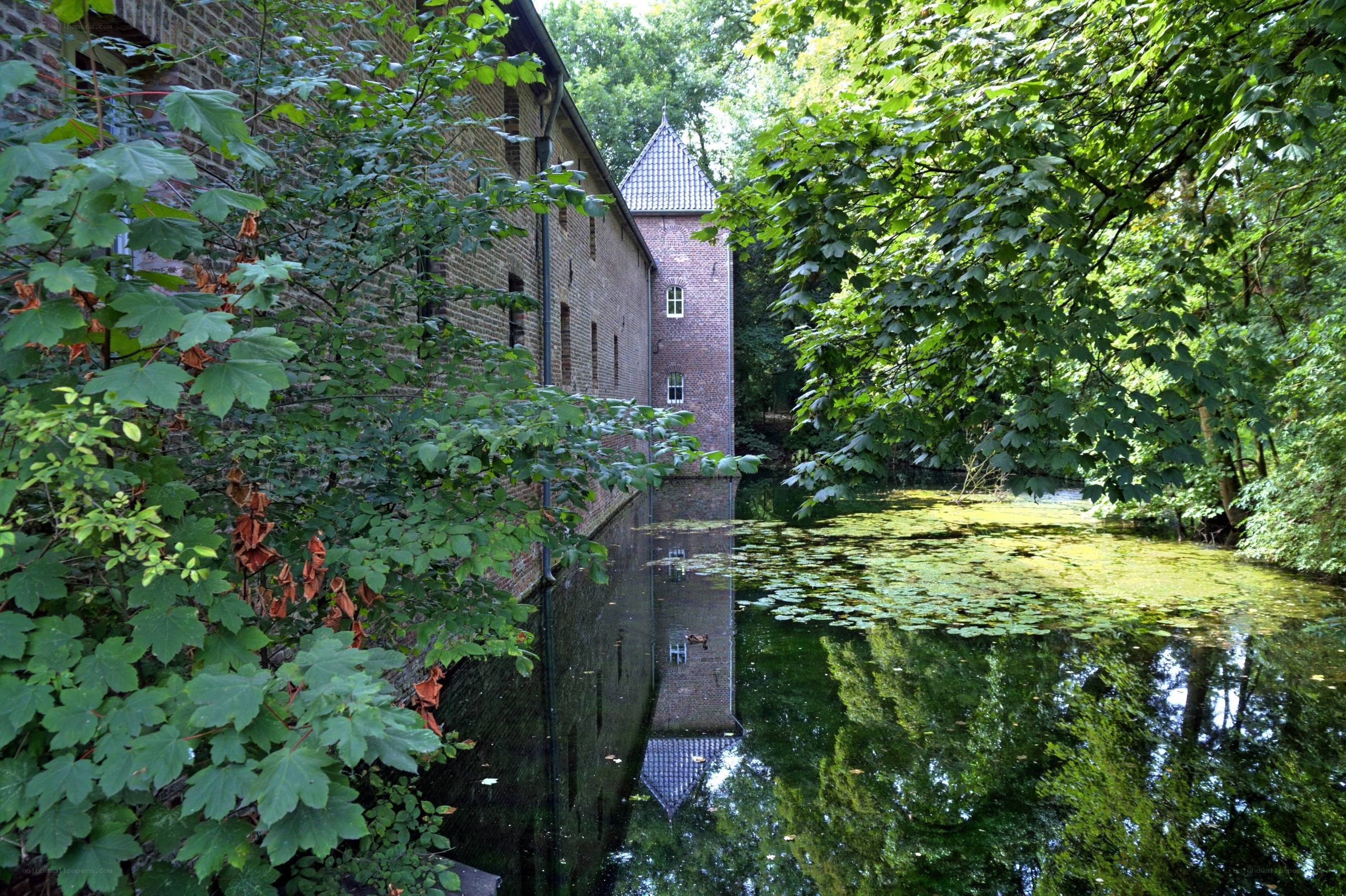 Brick building by a pond