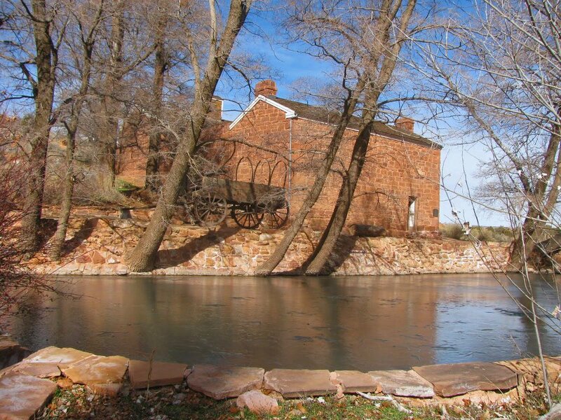Brick Building by River — Brown