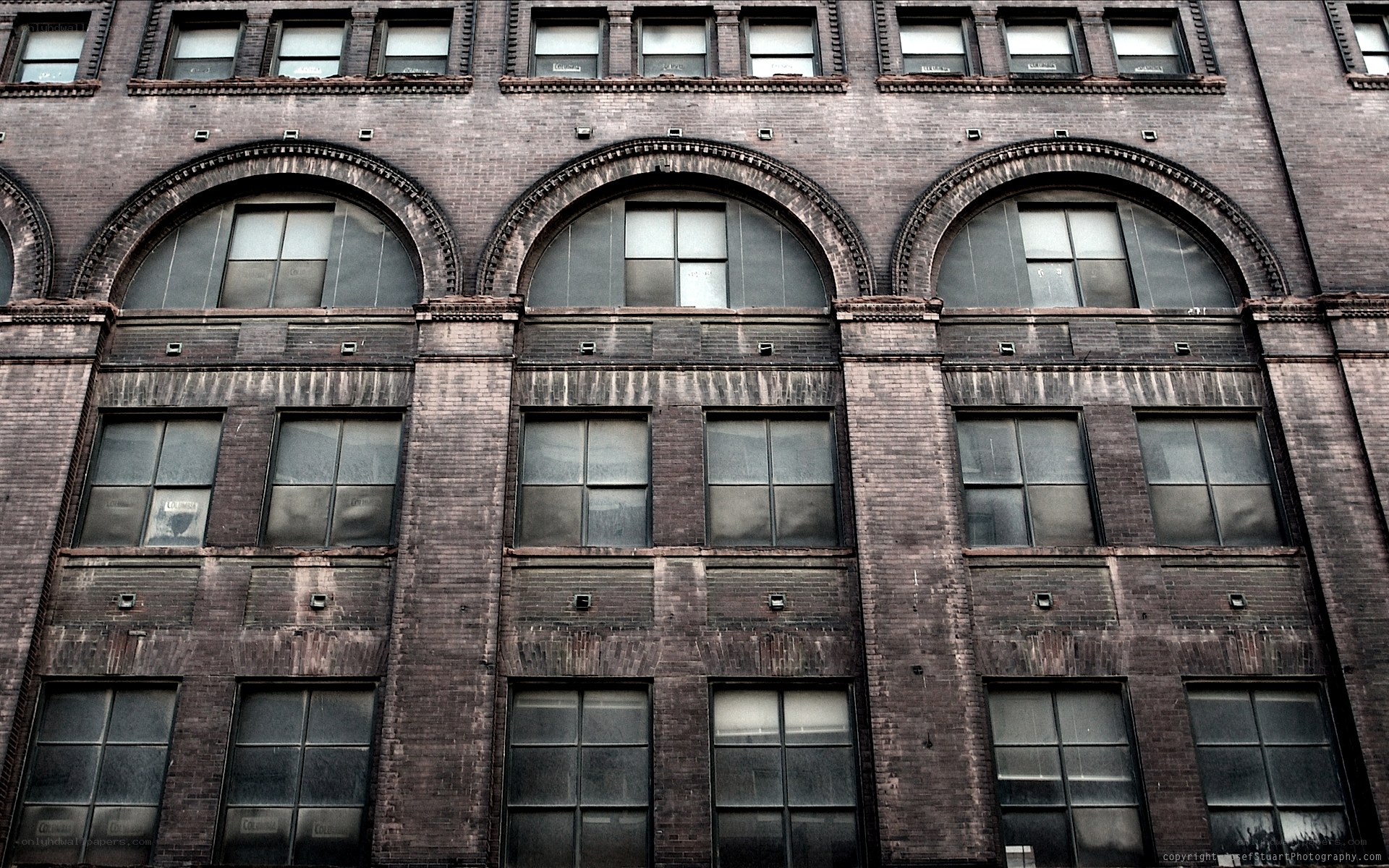 Brick building facade with arched windows
