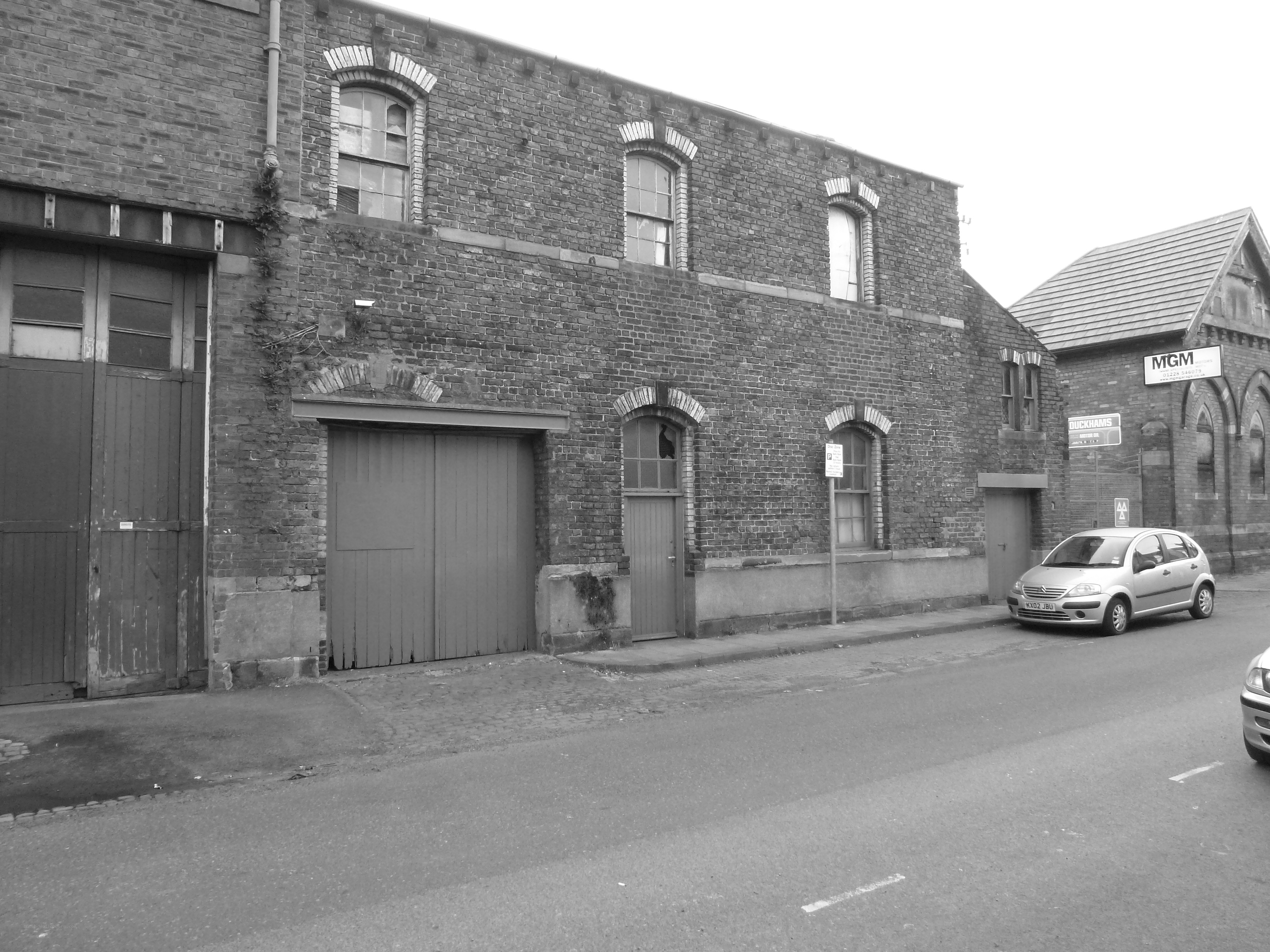 brick building with garage doors