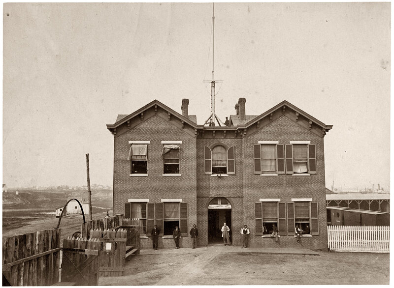 Brick building with men outside