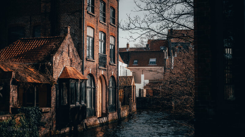 Brick Buildings Along Canal — Brown, Dramatic
