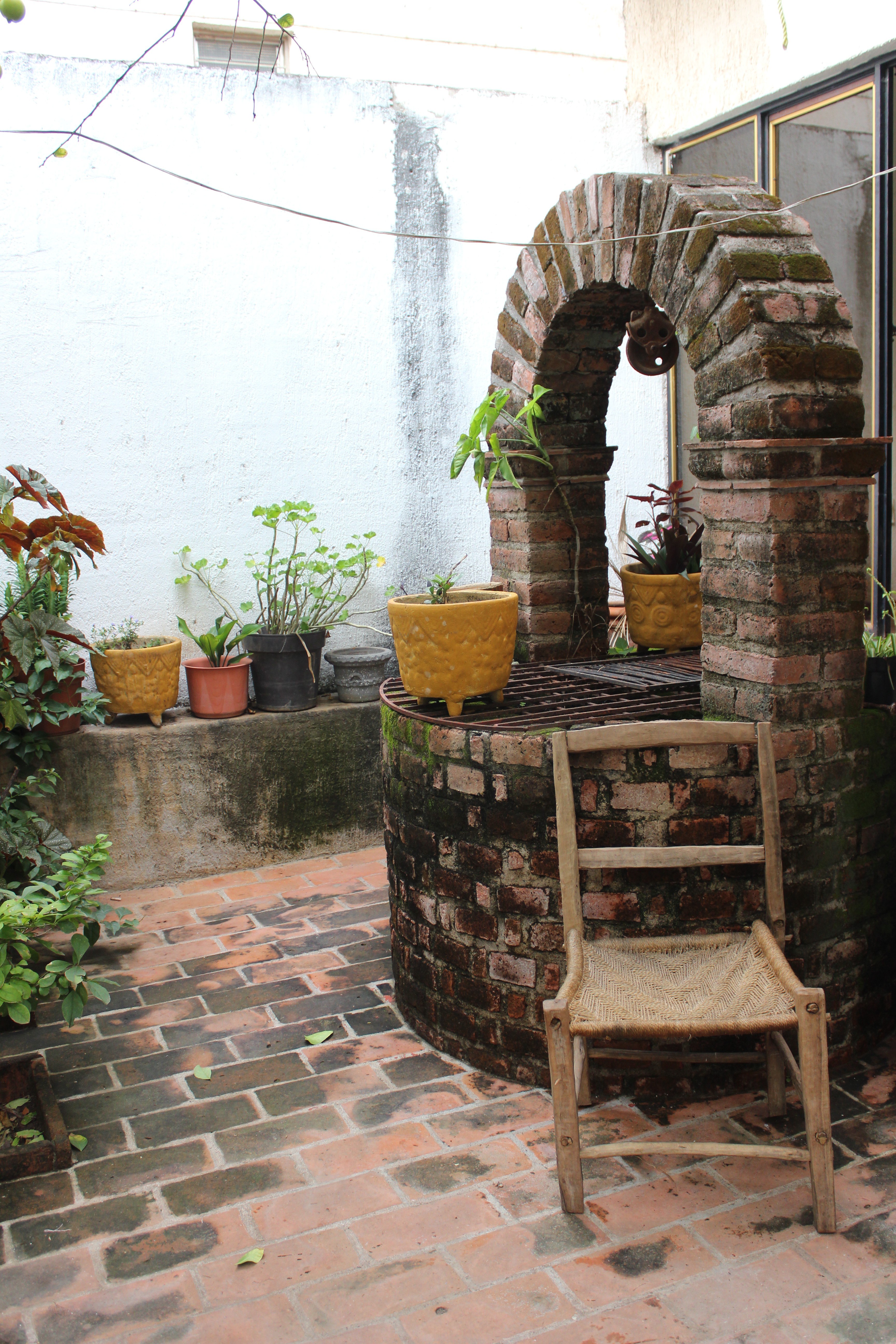 Brick courtyard with well and plants