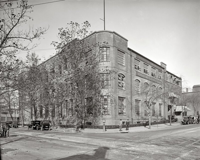 Brick factory building with vintage cars