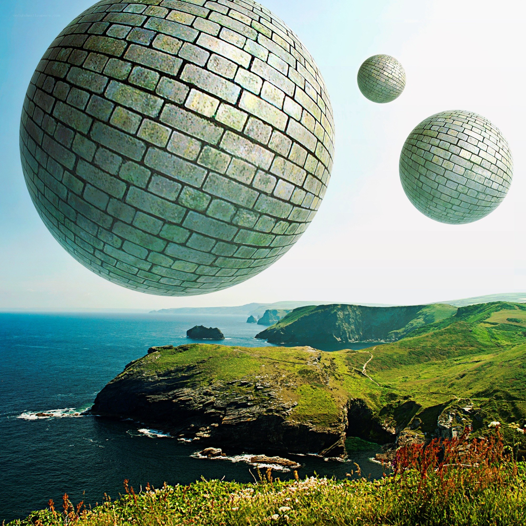 Brick spheres over coastal cliffs