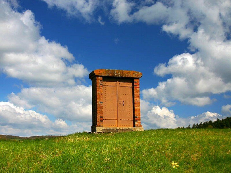 Brick structure on a grassy hill