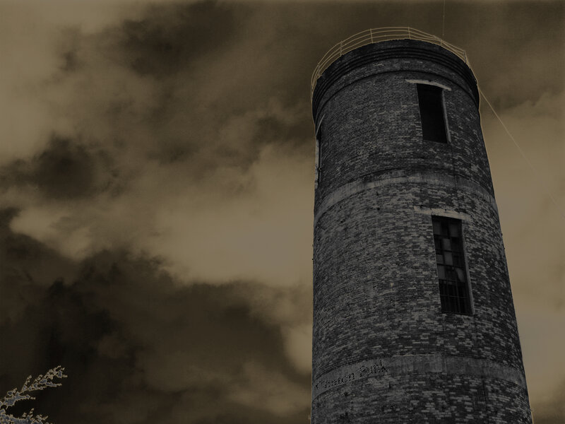 Brick tower under cloudy sky