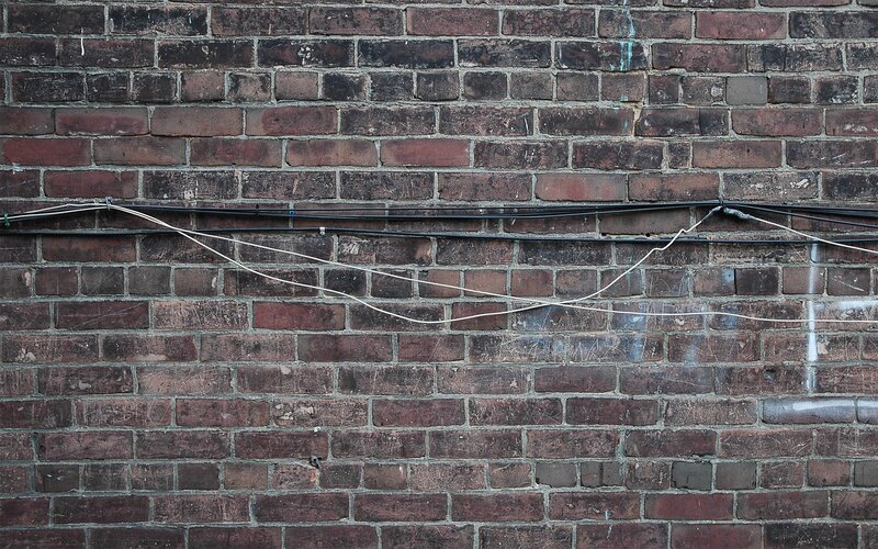 brick wall with cables