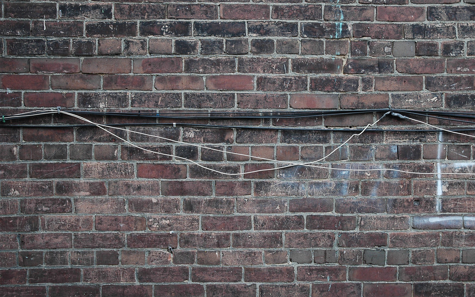 brick wall with cables