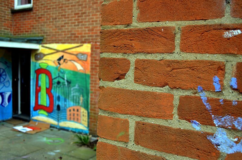 Brick wall with mural in background