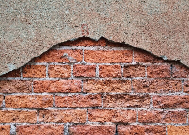 Brick wall with plaster damage