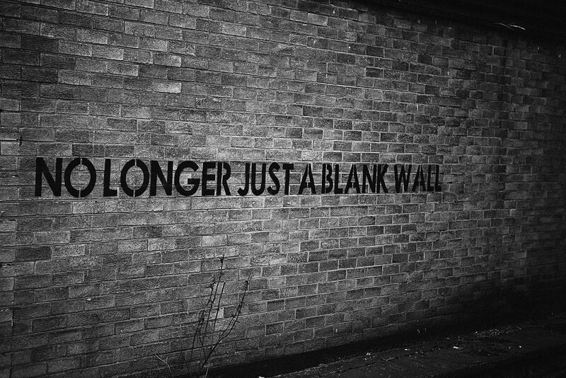 Brick Wall with Text — Black