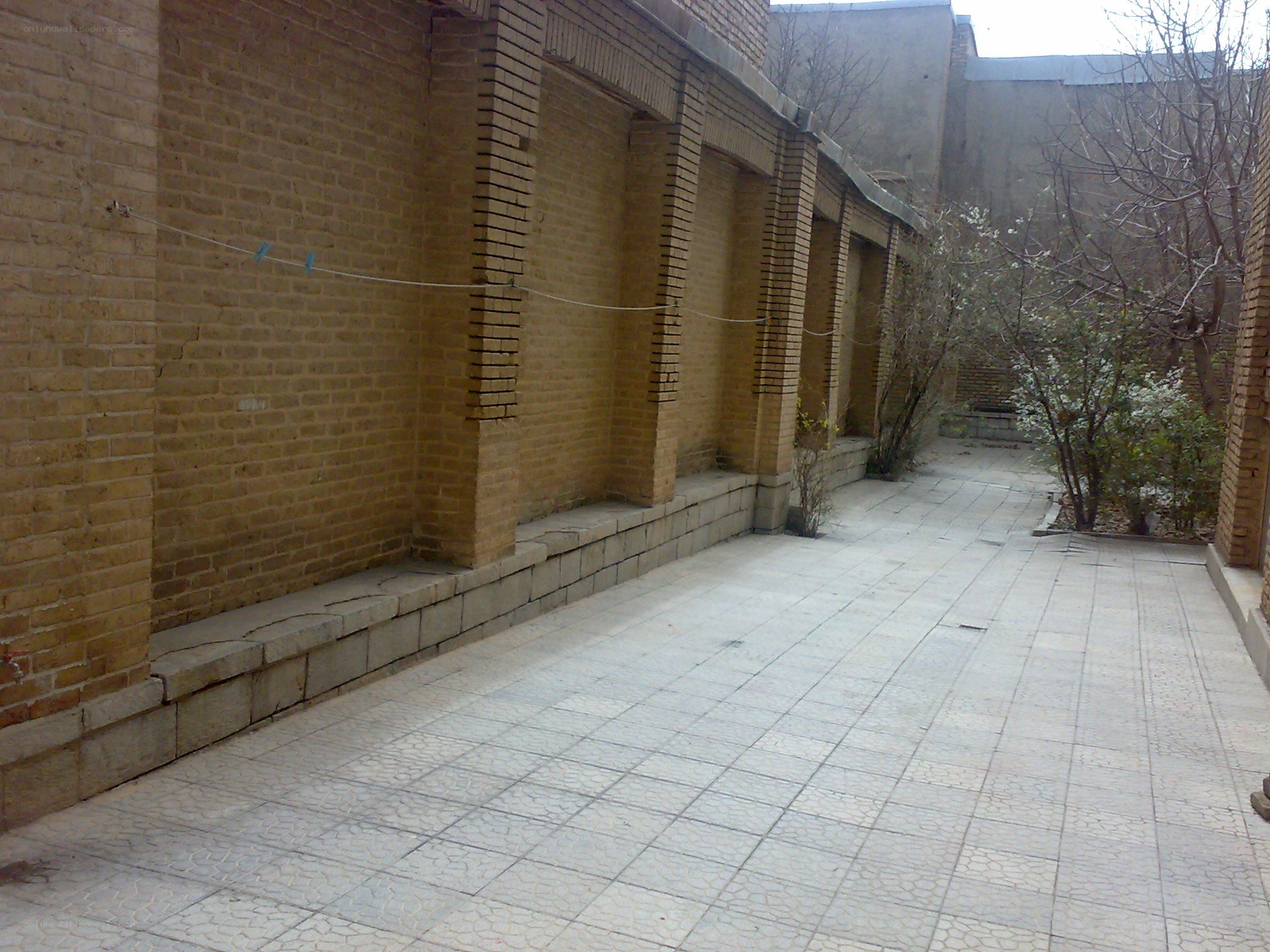 Brick-walled courtyard with tiled floor
