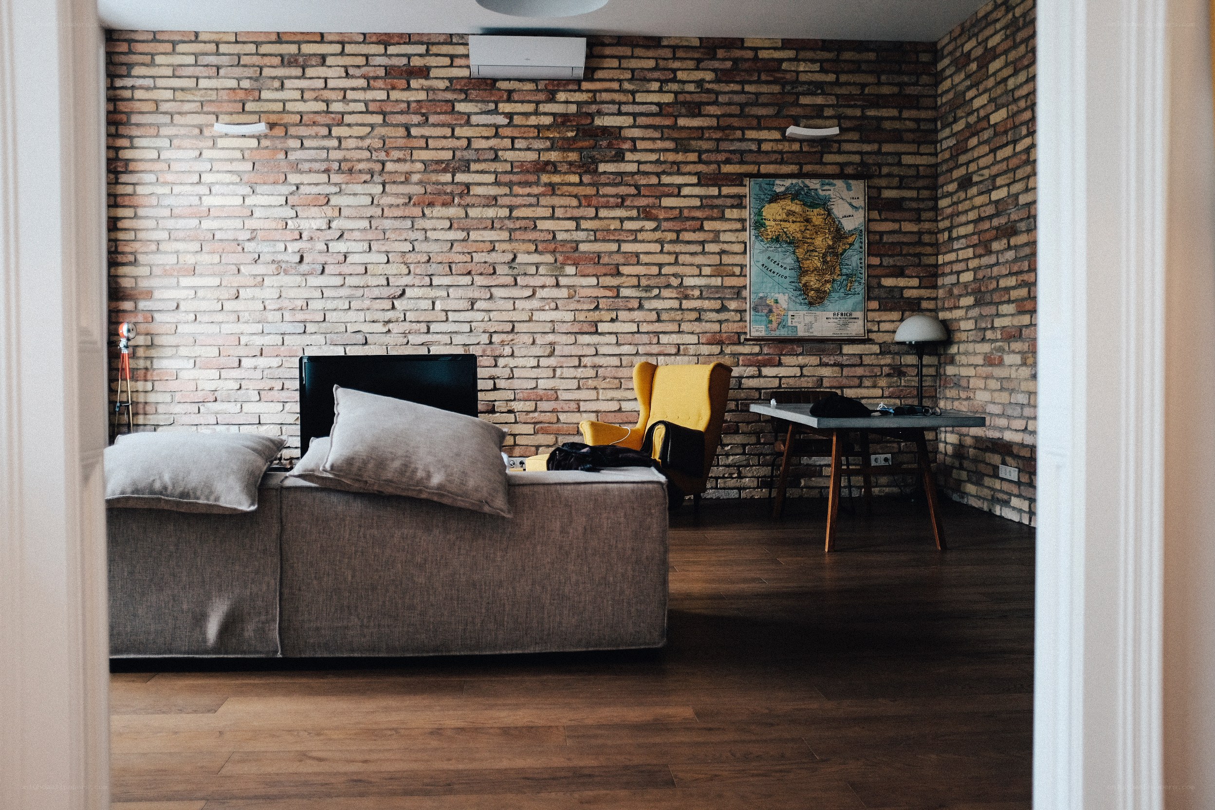 Brick-walled living room with map