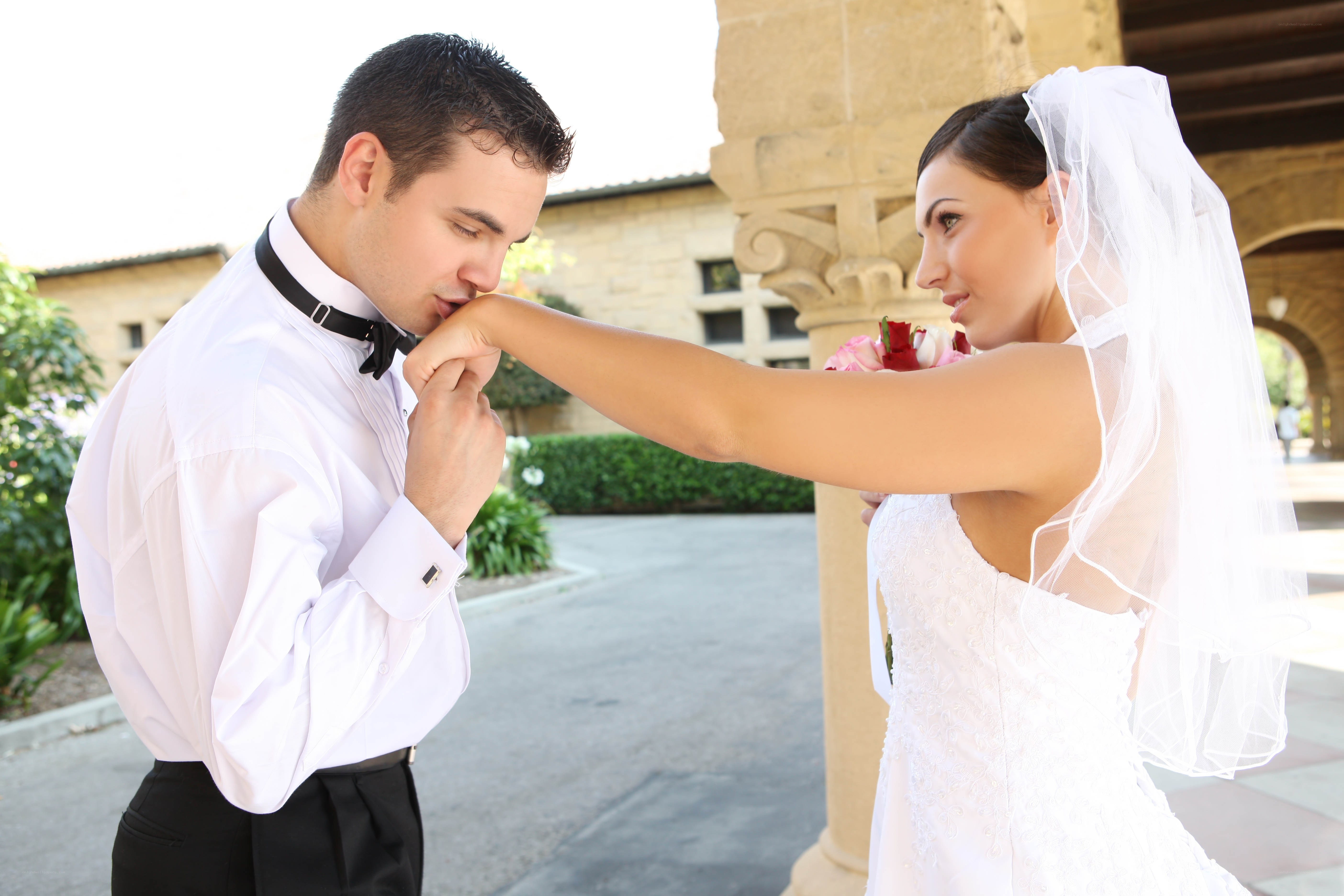 Bride adjusting groom's bow tie