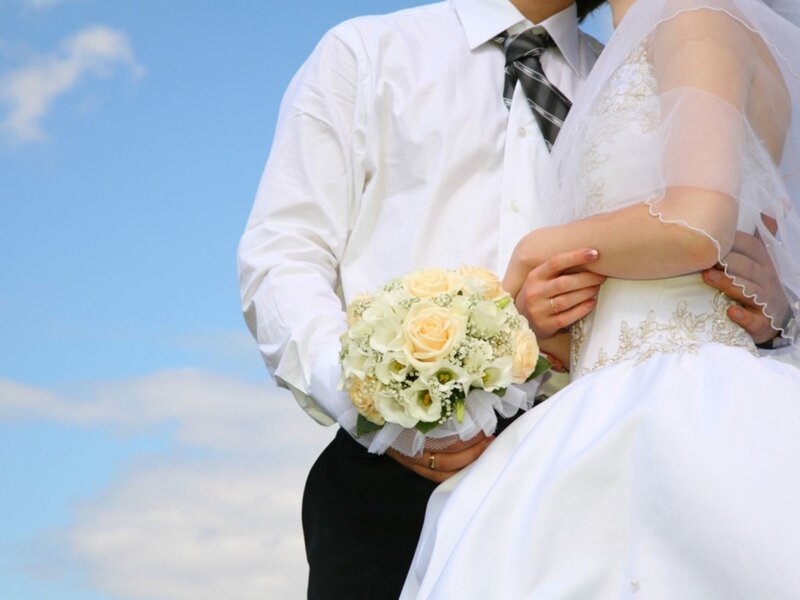 Bride and groom holding bouquet