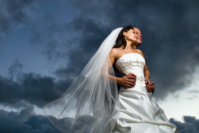 Bride and groom in stormy sky