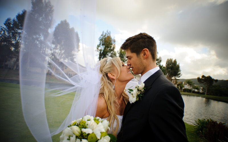 Bride and Groom Kissing — White, Romantic, Sunset, Photograph, Veil
