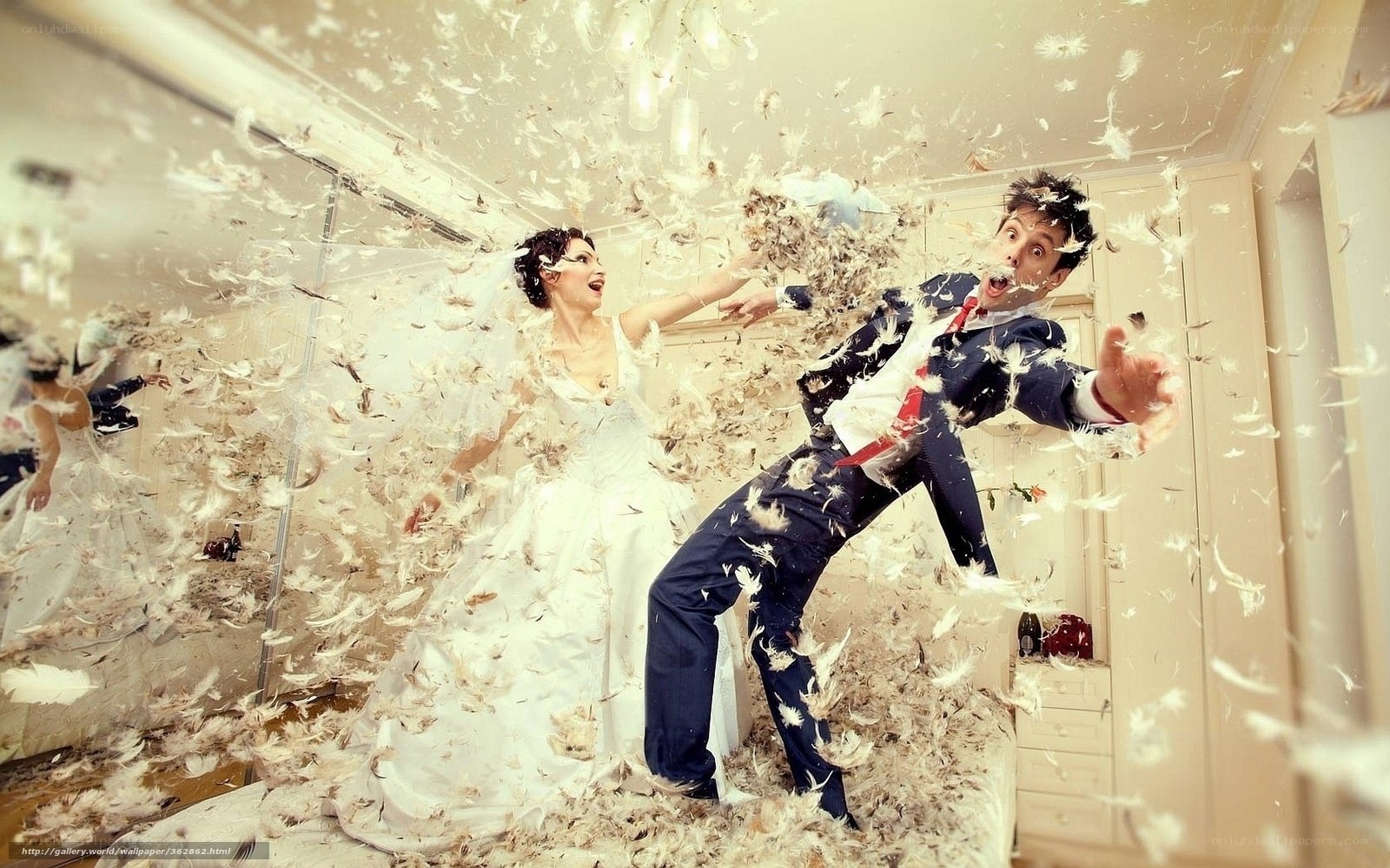 Bride and groom play with feathers