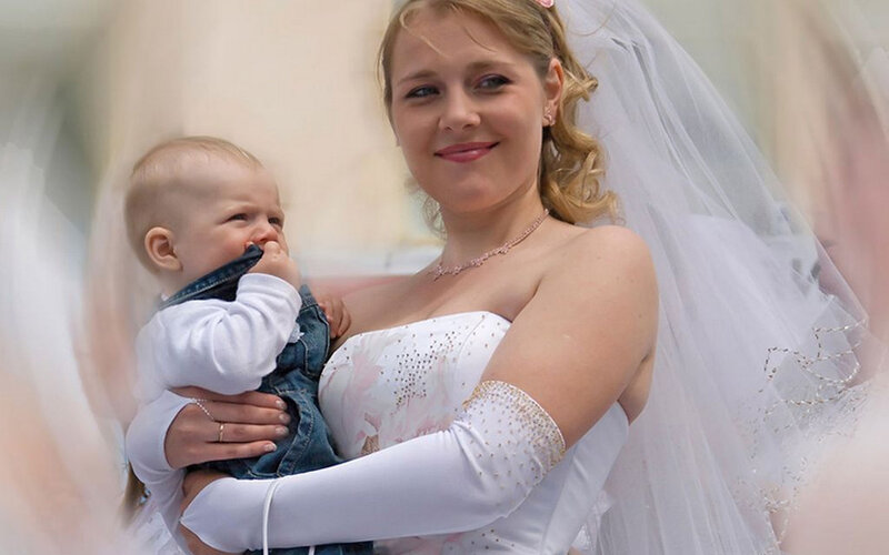 Bride Holding Baby