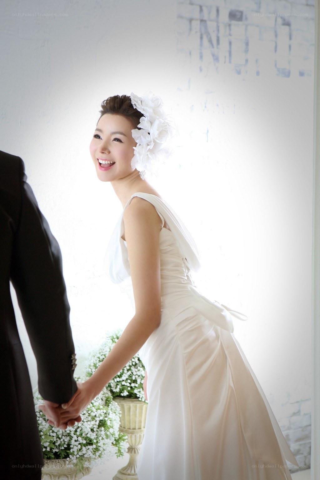 Bride holding groom's hand