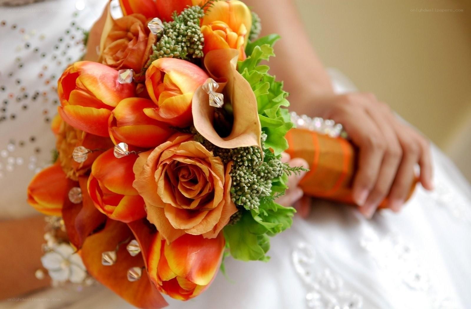 Bride holding orange bouquet