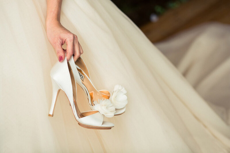 Bride Holding Wedding Shoes