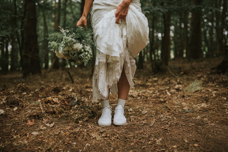 Bride in forest with sneakers