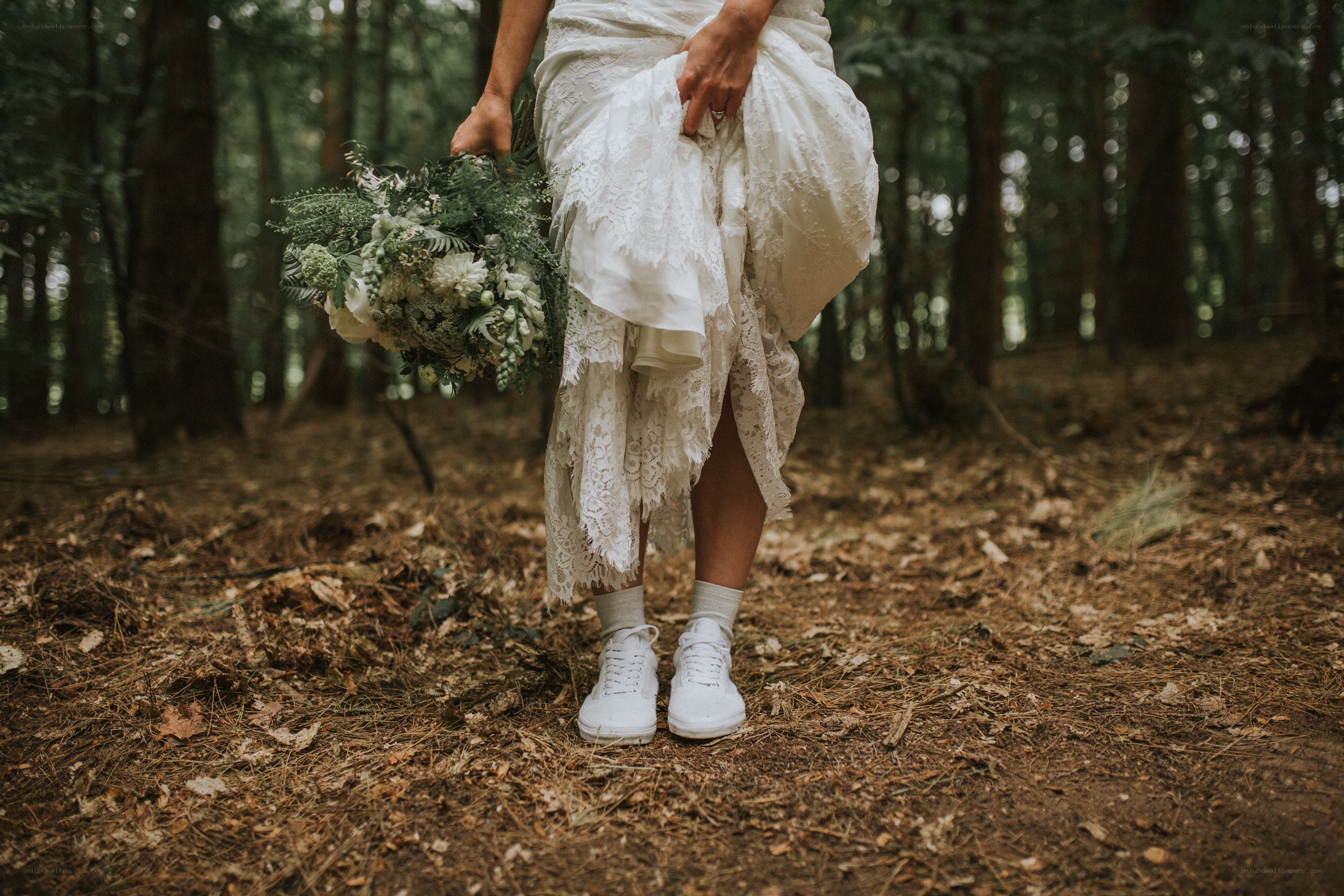 Bride in forest with sneakers