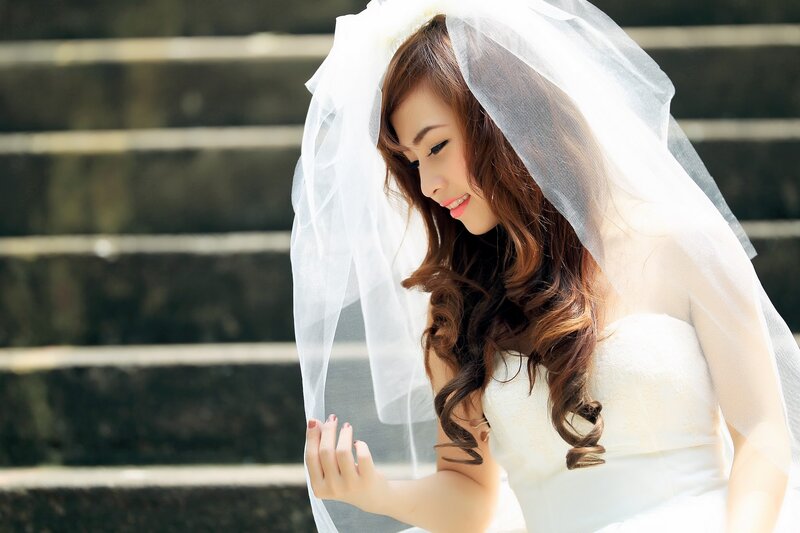 bride in veil on steps