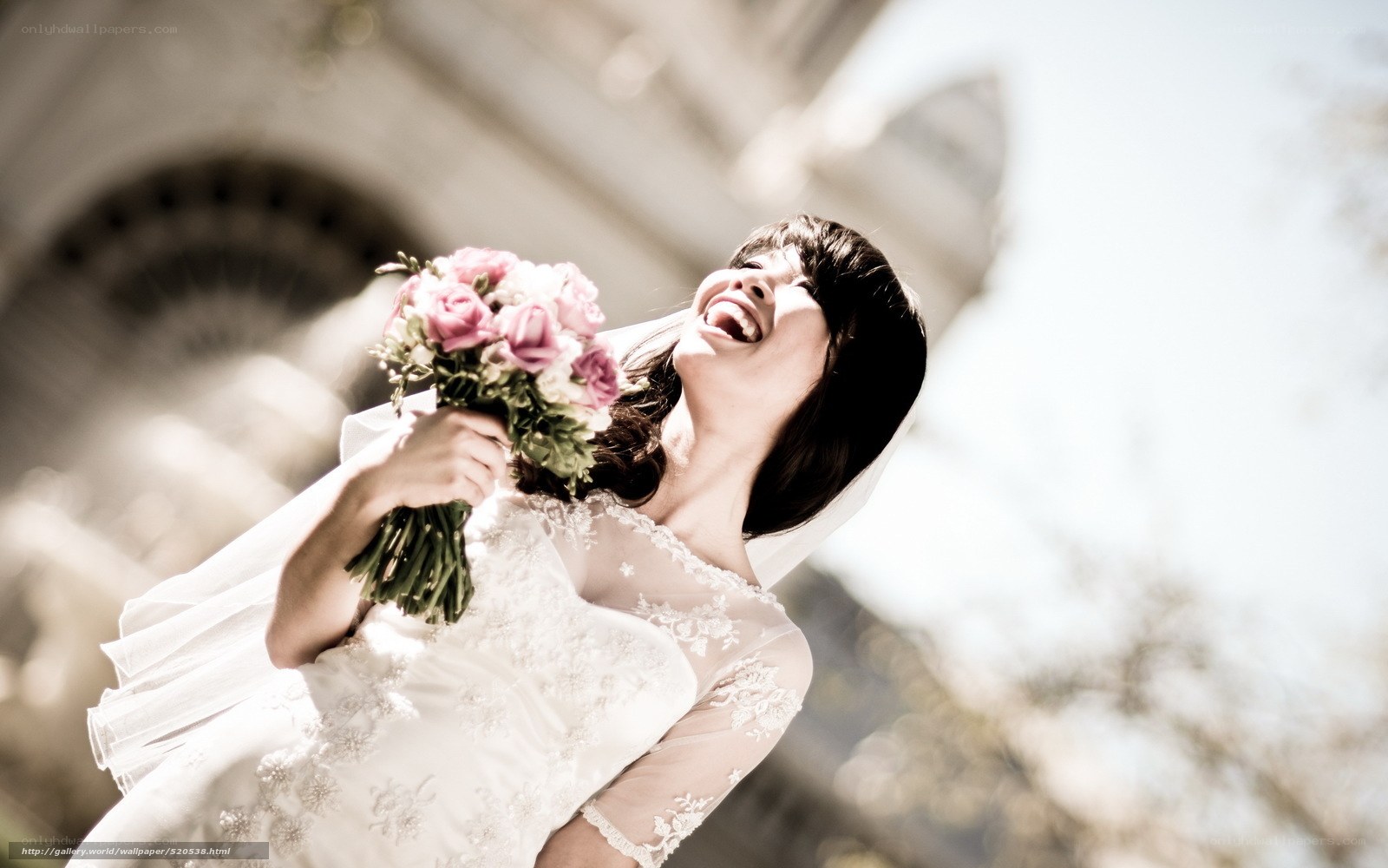 Bride laughing with bouquet