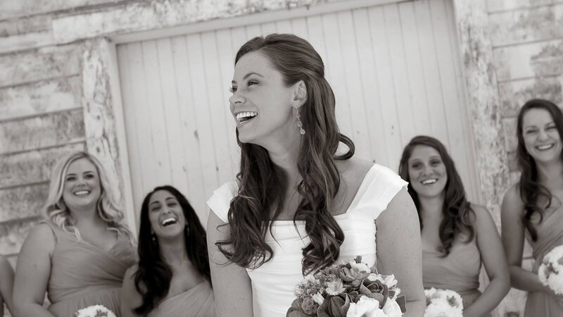 Bride laughing with bridesmaids