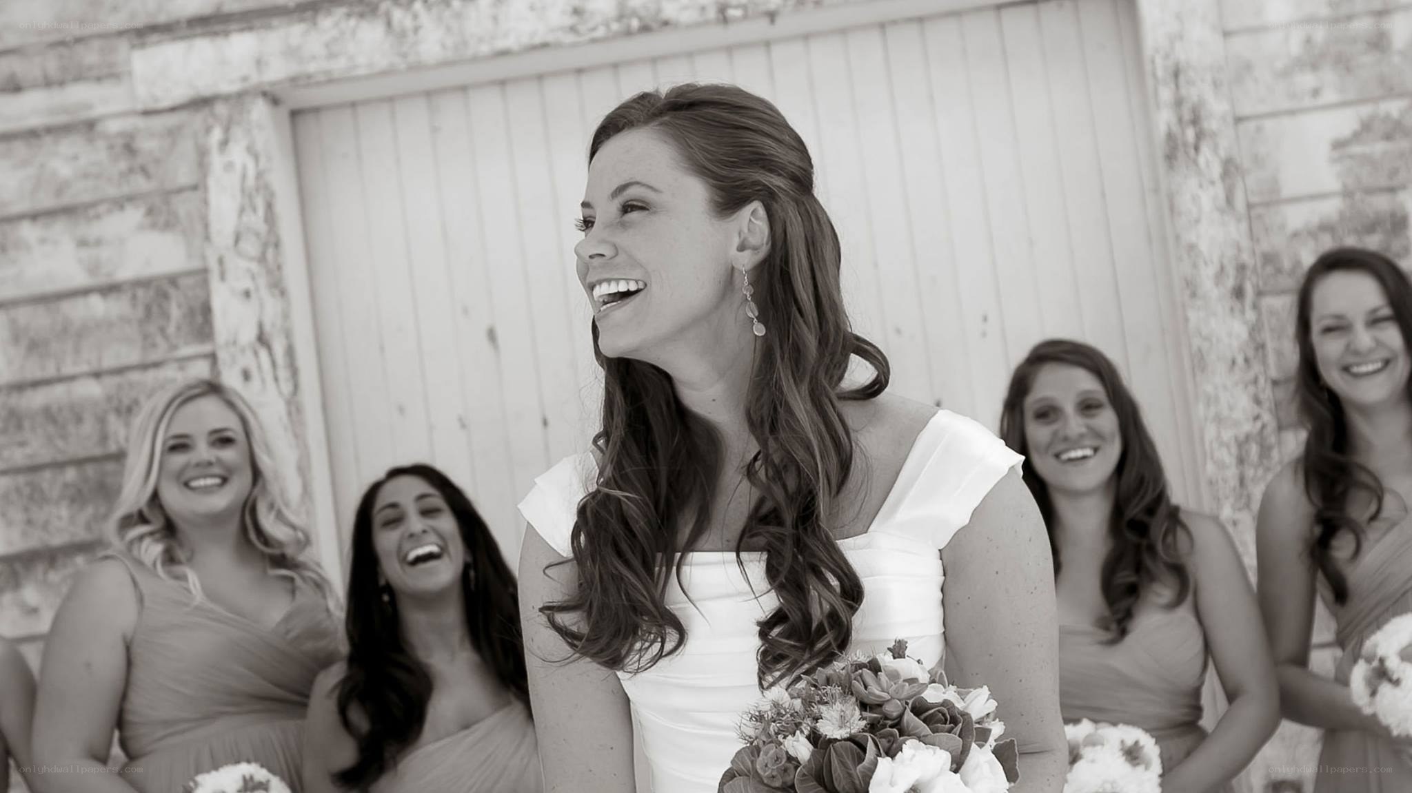 Bride laughing with bridesmaids